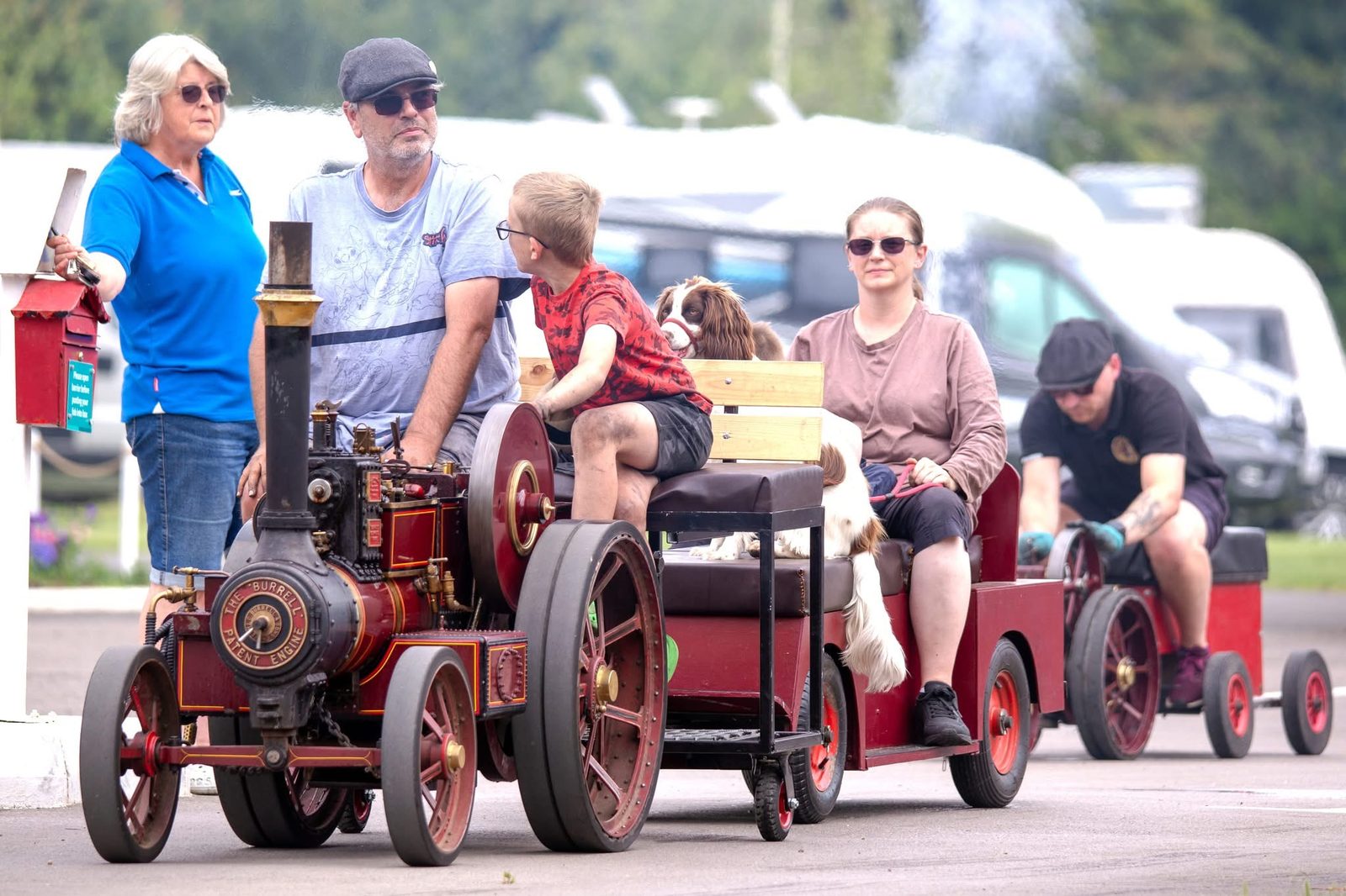 Nellie leading a convoy of miniature engines head-on, passengers and a springer spaniel aboard her trailer